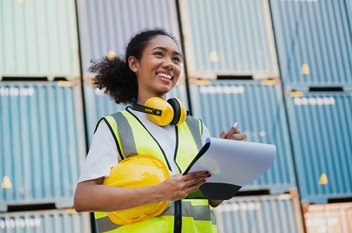 An Alfa Moving warehouse personnel in front of containers.