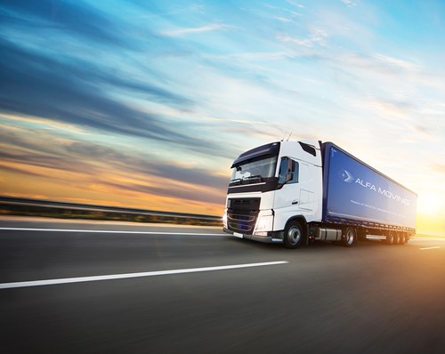 An Alfa Moving truck driving on a road with sun light in the background.
