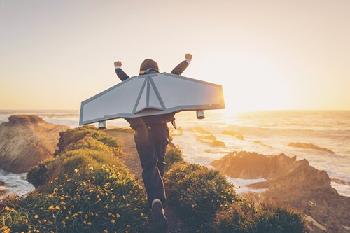 En person med vingar som flyger och representerar Alfas flyttjänster.