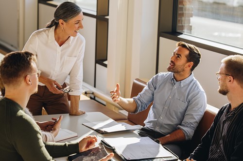 A group of business people from the Nordics discussing moving services provider.